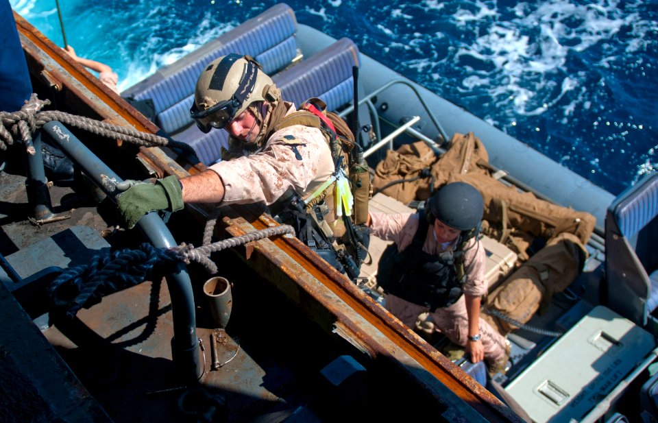 US Navy 111001-N-PB383-020 Marines assigned to the 11th Marine Expeditionary Unit (11th MEU) Maritime Raid Force embark a rigid-hull inflatable boa