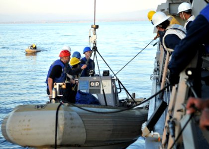 US Navy 110928-N-ZF681-143 Sailors raise a rigid-hull inflatable boat aboard the guided-missile destroyer USS Halsey (DDG 97). Halsey is underway c photo