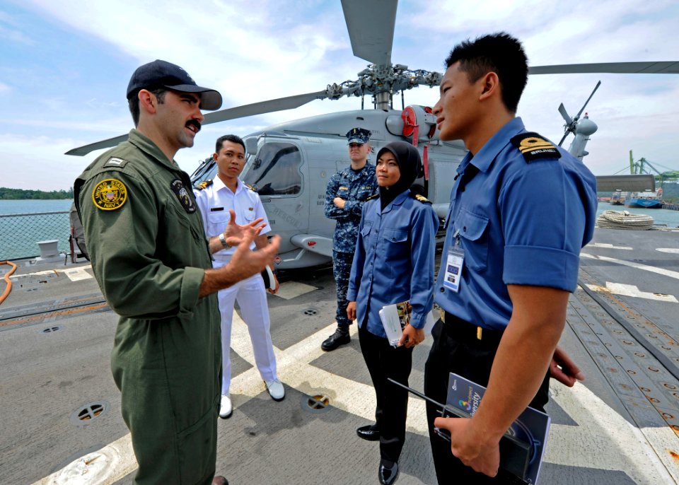 US Navy 111003-N-VH839-068 Lt. William Jourdan, left, embarked aboard the Arleigh Burke-class guided-missile destroyer USS Dewey (DDG 105), gives a