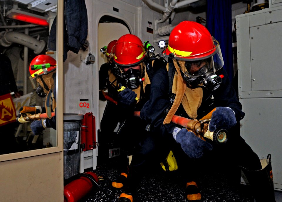 US Navy 110930-N-ZF681-490 ailors simulate fighting a fire during a general quarters drill aboard the guided-missile destroyer USS Halsey (DDG 97)