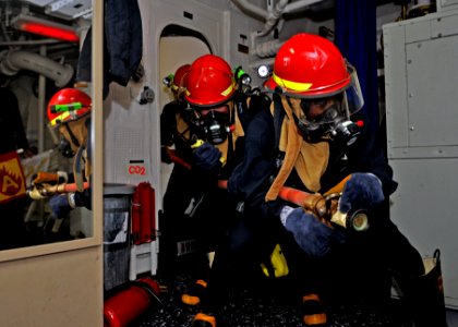 US Navy 110930-N-ZF681-490 ailors simulate fighting a fire during a general quarters drill aboard the guided-missile destroyer USS Halsey (DDG 97)