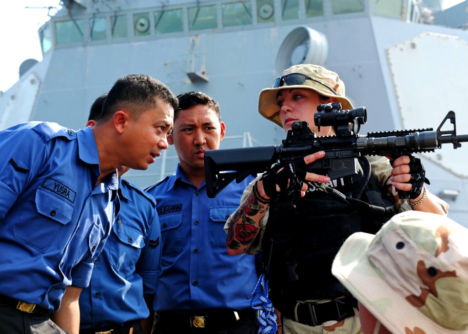 US Navy 110930-N-ED900-314 Fire Controlman 2nd Class Christi Hoopes, right, a member of the visit, board, search and seizure team