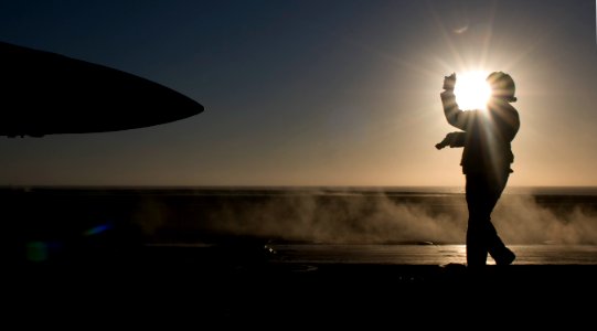 US Navy 111002-N-OK922-391 Aviation Boatswain's Mate (Handling) 3rd Class Tamara Sewell directs an F-A-18F Super Hornet