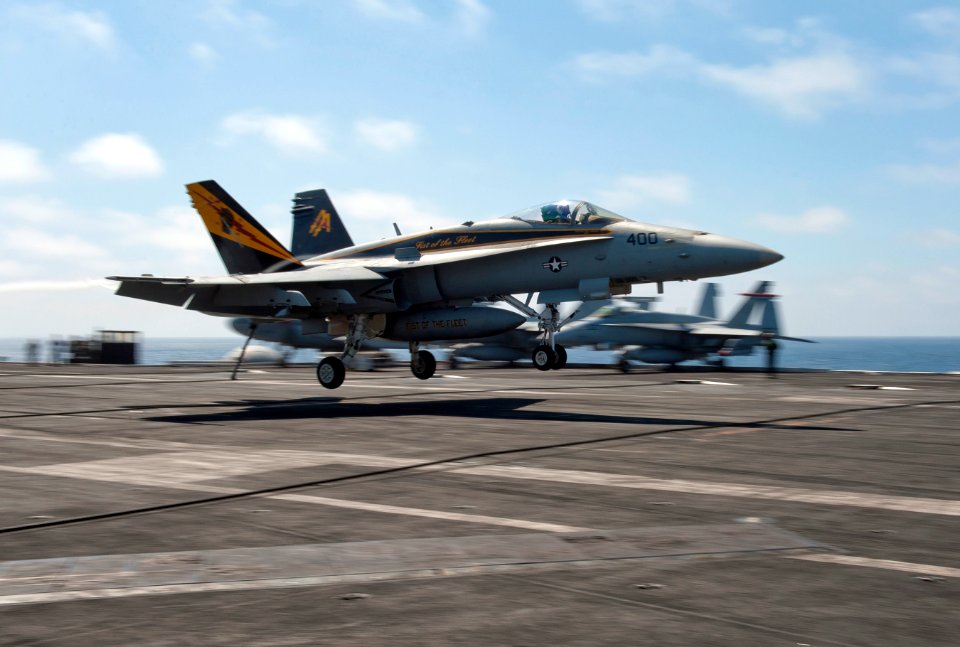 US Navy 111001-N-DR144-007 An F-A-18C Hornet assigned to Strike Fighter Squadron (VFA) 25 makes an arrested landing aboard the Nimitz-class aircraf