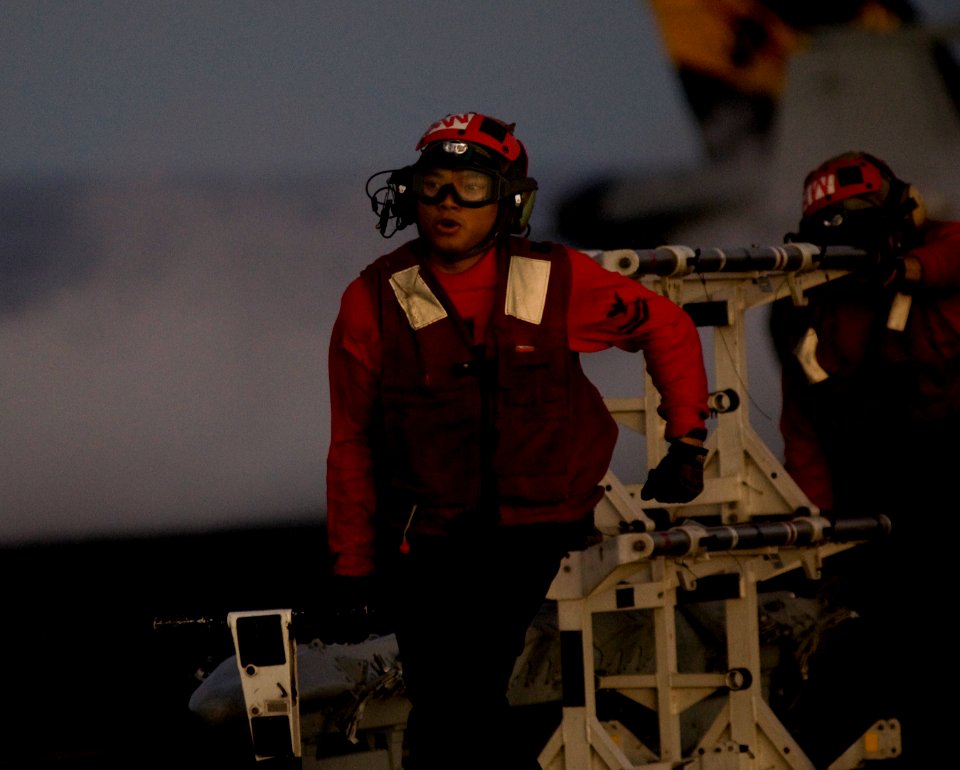 US Navy 110929-N-TZ605-664 Aviation Ordnanceman 2nd Class Mondarasmey Luos, assigned to Strike Fighter Squadron (VFA) 25, prepares to offload ordna