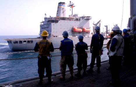 US Navy 111004-N-GH121-051 Sailors aboard the amphibious dock landing ship USS Whidbey Island (LSD 41) stand by as the ship makes its approach duri