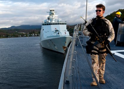 US Navy 111003-N-FI736-006 The Royal Danish navy command and support ship HDMS Esbern Snare (L17) is moored in the background as Fire Controlman 2n