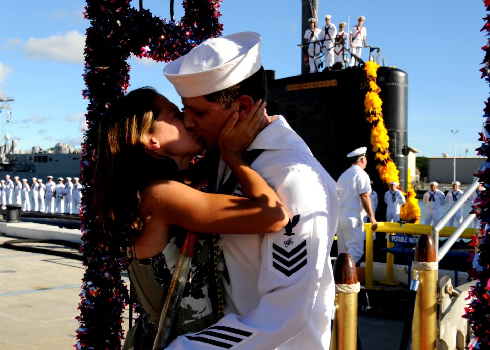 US Navy 110930-N-UK333-097 Electronics Technician 1st Class James Bowler is kissed by his wife as he is the first to disembark from the Los Angeles