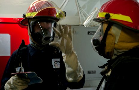 US Navy 111003-N-DR144-076 Personnel Specialist Seaman James Bryan, left, and Personnel Specialist 3rd Class Luis Cano, both investigators assigned photo