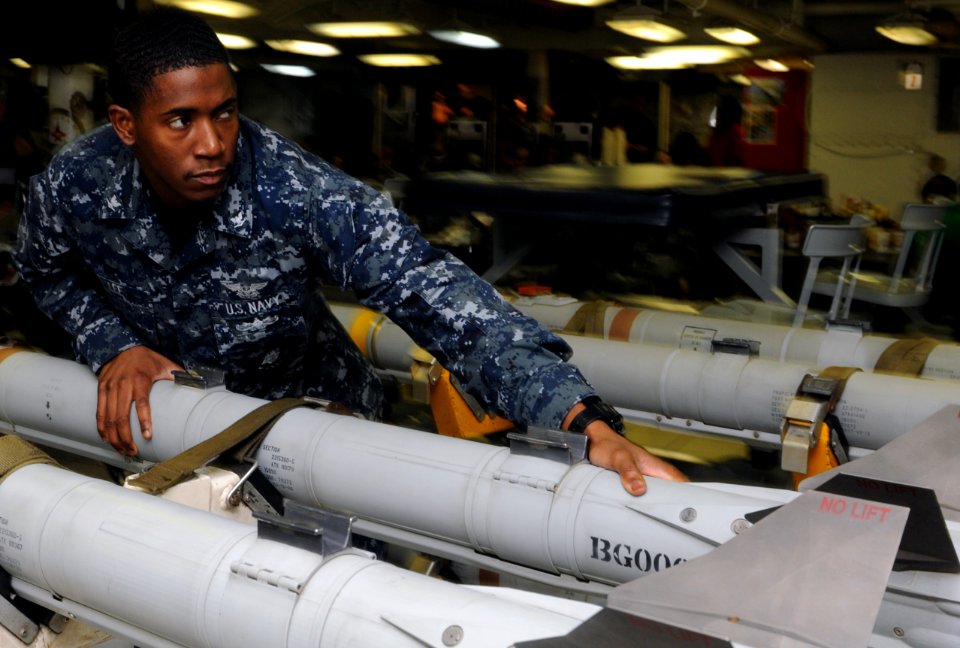 US Navy 111003-N-YC505-005 Aviation Ordnanceman 3rd Class Joseph M. Lee transports ordnance aboard the aircraft carrier USS George H.W. Bush (CVN 7