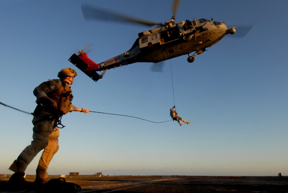 US Navy 111006-N-DU438-029 Sailors assigned to Explosive Ordnance Disposal Mobile Unit (EODMU) 2 rappel from an MH-60S Sea Hawk helicopter