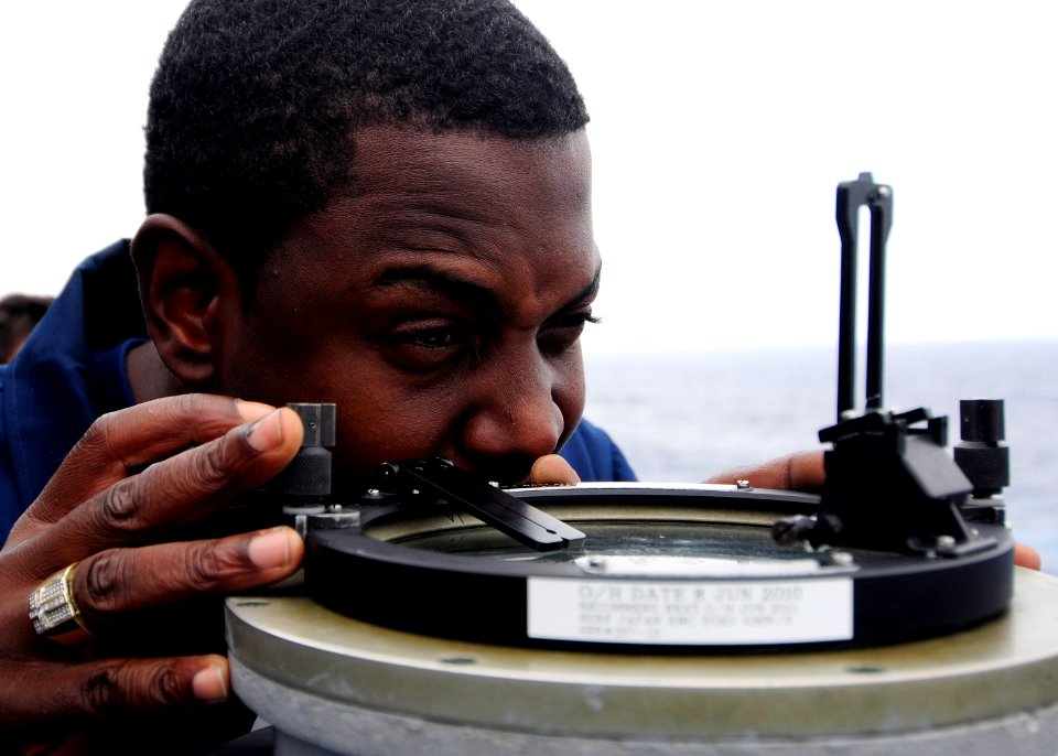 US Navy 111003-N-WJ771-014 Chief Quartermaster Raymond E. Smith uses an azimuth circle from the port bridge wing of the forward-deployed amphibious
