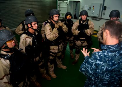 US Navy 111006-N-FI736-240 The visit, board, search and seizure team assigned to the guided-missile destroyer USS Arleigh Burke (DDG 51) is debrief photo