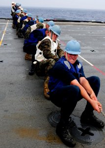 US Navy 111003-N-WJ771-152 ailors and Marines assigned to the forward-deployed amphibious transport dock ship USS Denver (LPD 9) heave around on a