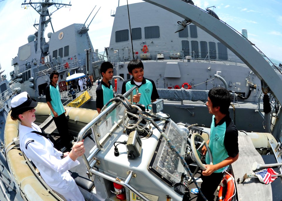 US Navy 111004-N-ED900-270 Gas Turbine System Technician (Electrical) Fireman Allison Hayes shows a rigid-hull inflatable boat to students from Kap