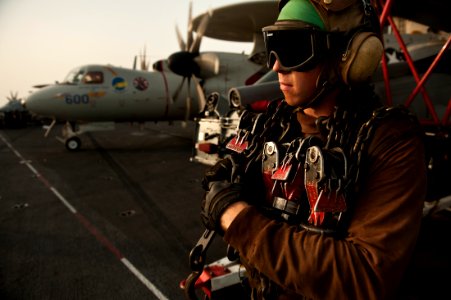 US Navy 111003-N-BT887-269 Aviation Machinist's Mate Airman Andrew Bunk adjusts chains in preparation for flight operations