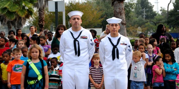 US Navy 111007-N-GO855-014 Logistics Specialist 2nd Class Robert Bello and Yeoman 2nd Class Michael Corrales await the commencement of the ceremony