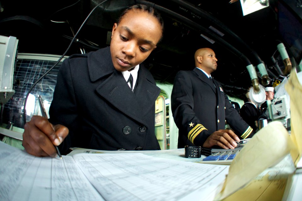 US Navy 111005-N-ZC343-163 hips navigator Cmdr. Bernard Knox, right, tracks the position of the amphibious assault ship USS Bonhomme Richard (LHD 6