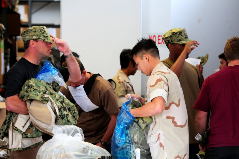 US Navy 111005-N-GT324-063 A Sailor assigned to Naval Special Warfare (NSW) Logistics Support Unit (LOGSU) 1, bags up uniform pieces