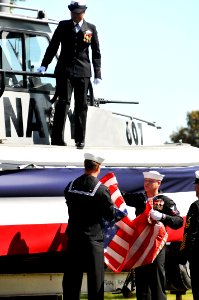 US Navy 111003-N-GL340-056 Sailors remove and fold an American flag during the MSRON-5 decommissioning ceremony