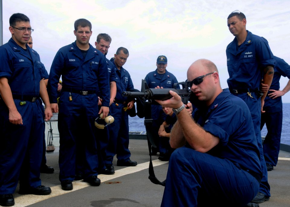 US Navy 111005-N-KB052-042 Gunner's Mate 1st Class Russell Rotolo demonstrates the proper handling and firing procedures of the M-16 A3 rifle