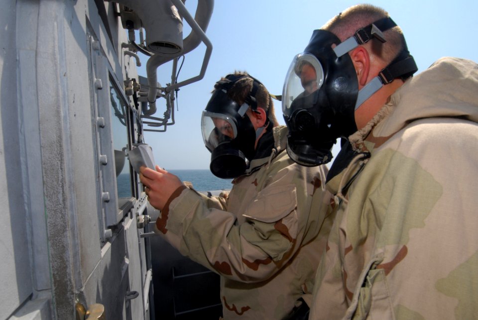 US Navy 111004-N-DU438-202 Operations Specialist Seaman Apprentice Taylor Anderson, left, and Seaman David Burch write the status of detected airbo