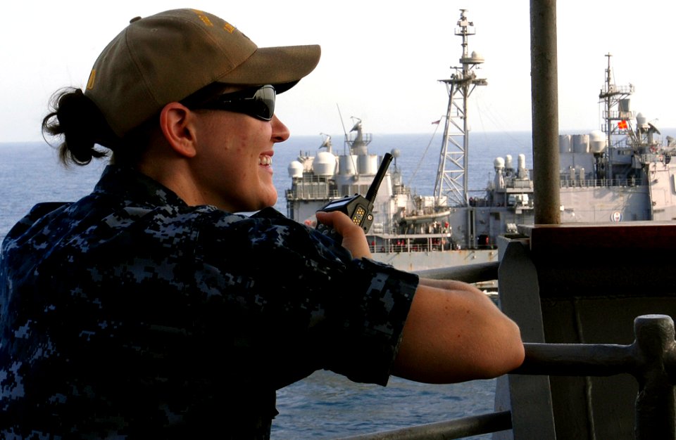 US Navy 111004-N-GH121-043 Lt. j.g. Martha Rowe, officer of the deck, observes the ship's progress from the bridge wing of the amphibious dock lan