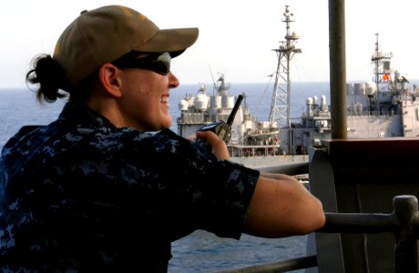 US Navy 111004-N-GH121-043 Lt. j.g. Martha Rowe, officer of the deck, observes the ship's progress from the bridge wing of the amphibious dock lan