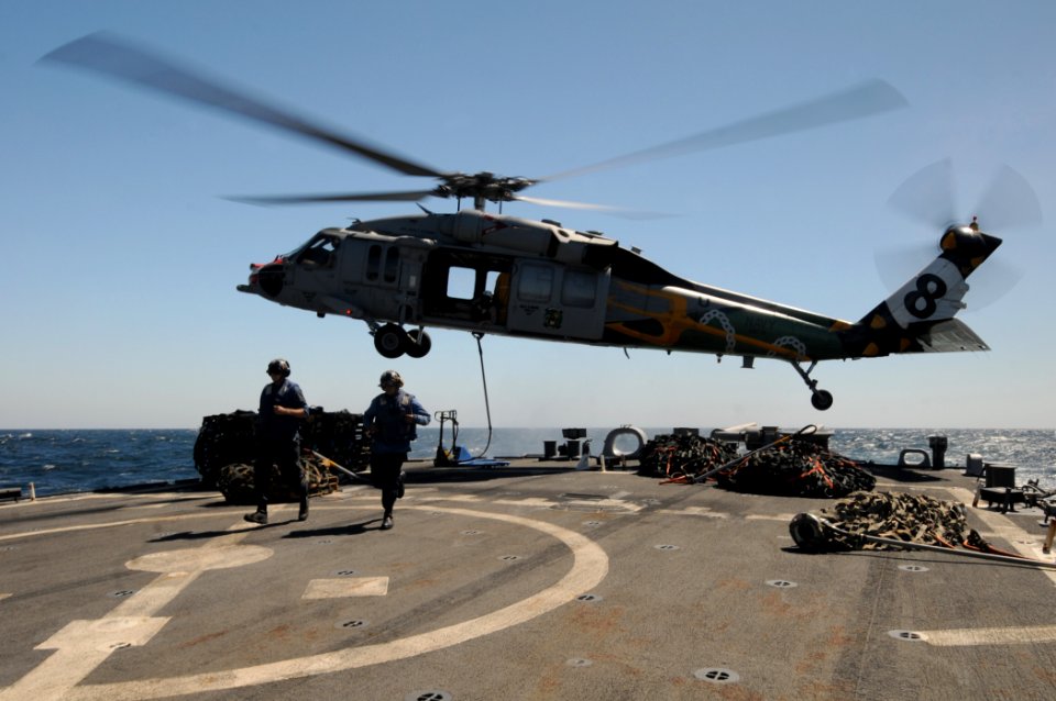 US Navy 111005-N-XQ375-312 Seaman Matt Binnie, left, and Damage Controlman 2nd Class Ruben Cruz clear the flight deck of the guided-missile destroy