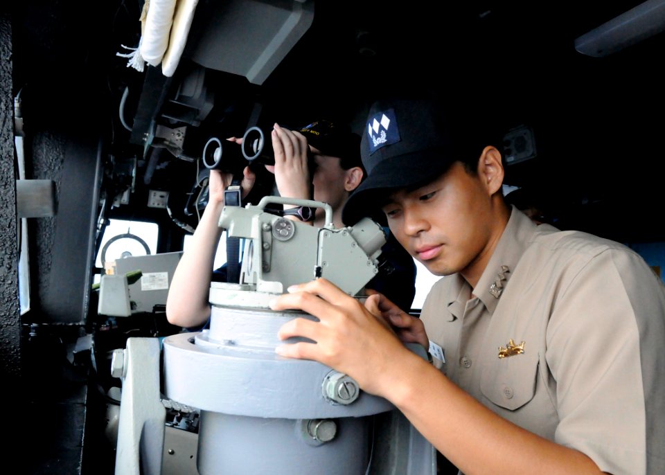 US Navy 111008-N-KB052-153 Republic of Korea navy Lt. Wook Hyun Min uses an alidade from the pilothouse of the Ticonderoga-class guided-missile cru