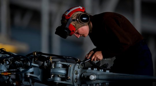 US Navy 111005-N-TU221-052 Airman Christyl Roper performs maintenance on the propellers of an MH-60R Sea Hawk helicopter in the hangar bay