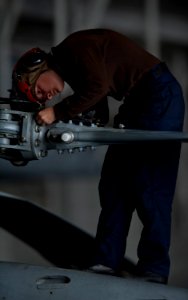 US Navy 111005-N-TU221-047 Airman Christyl Roper performs maintenance on the propellers of an MH-60R Sea Hawk helicopter