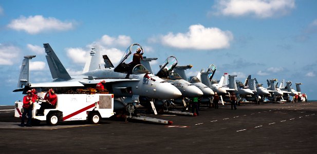 US Navy 111010-N-BT887-024 Sailors prepare the flight deck and aircraft for flight operations aboard the Nimitz-class aircraft carrier USS John C