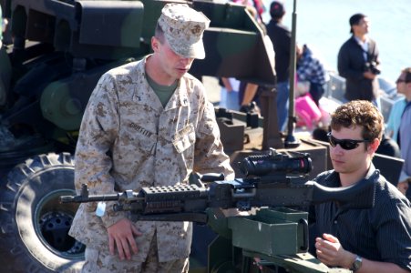 US Navy 111008-N-ZC343-188 Visitors talk to Sailors and Marines while viewing various displays of military equipment aboard the amphibious assault