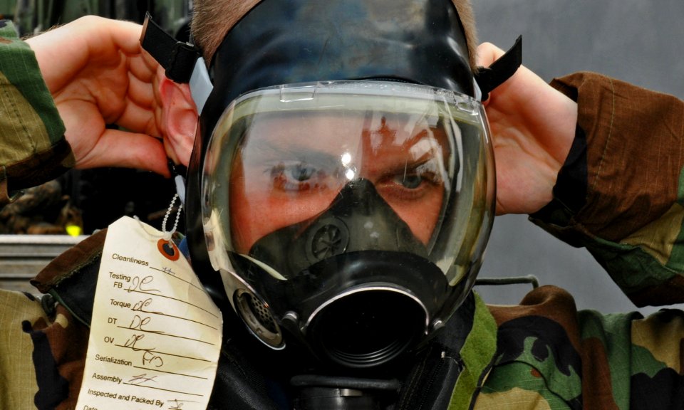 US Navy 111008-N-MW330-117 Hull Maintenance Technician Fireman Recruit Alexander Huntress dons his gas mask while participating in advanced chemica