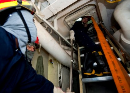 US Navy 111009-N-FI736-031 Sailors aboard the guided-missile destroyer USS Arleigh Burke (DDG 51) participate in a damage control training exercise