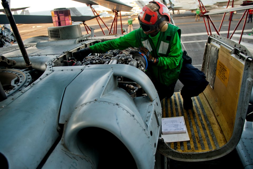 US Navy 111011-N-BT887-412 Airman Joyce Cruz examines an MH-60R Sea Hawk helicopter assigned to the Raptors of Helicopter Maritime Strike Squadron
