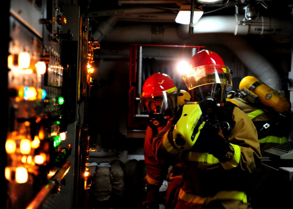 US Navy 111011-N-ED900-240 Fire assessment members use a naval firefighting thermal imager (NFTI) in a main engine room to gauge temperatures durin