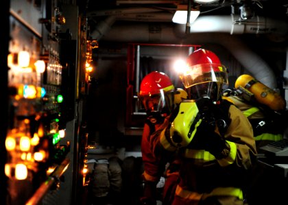 US Navy 111011-N-ED900-240 Fire assessment members use a naval firefighting thermal imager (NFTI) in a main engine room to gauge temperatures durin