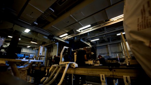 US Navy 111008-N-TU221-409 Sailors work on the frame of a jet engine inside the jet shop of the Nimitz-class aircraft carrier USS Abraham Lincoln (