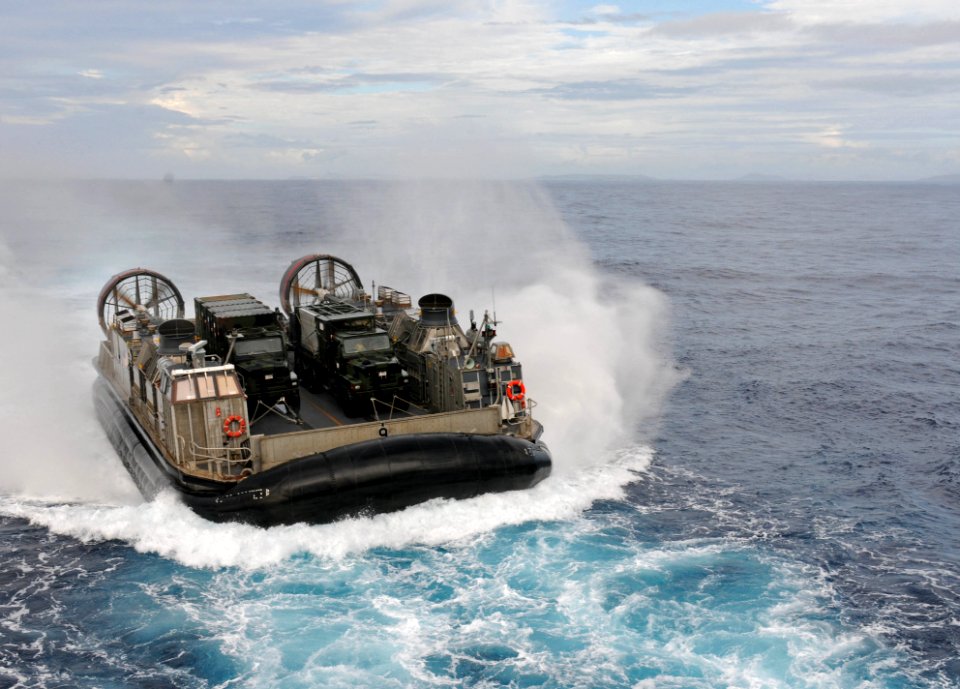 US Navy 111011-N-MW330-066 Landing Craft Air Cushion (LCAC) 9 heads towards the forward deployed amphibious dock landing ship USS Germantown (LSD 4