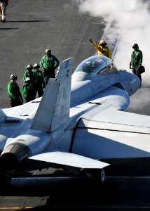 US Navy 111006-N-YB753-074 An aviation boatswain's mate (handling) directs an F-A-18F Super Hornet assigned to the Bounty Hunters of Strike Fighter