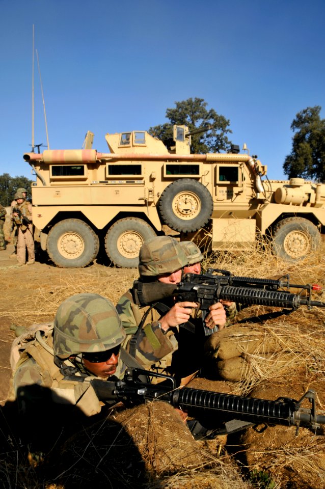 US Navy 111008-N-SM578-038 Seabees assigned to Naval Mobile Construction Battalion (NMCB) 40, defend their camp in a simulated firefight as part of