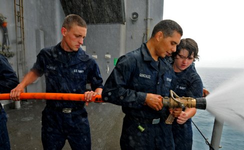 US Navy 111010-N-MW330-032 nformation Systems Technician Seaman Zachary Crowell, left, Seaman Apprentice Christopher Gonzalez, and Seaman Brooke Ha