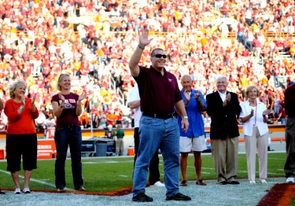 US Navy 111007-N-XX999-001 Lt. Cmdr. Josh Feldman waves to the crowd at Lane Stadium during a halftime ceremony at the VT and University of Miami f