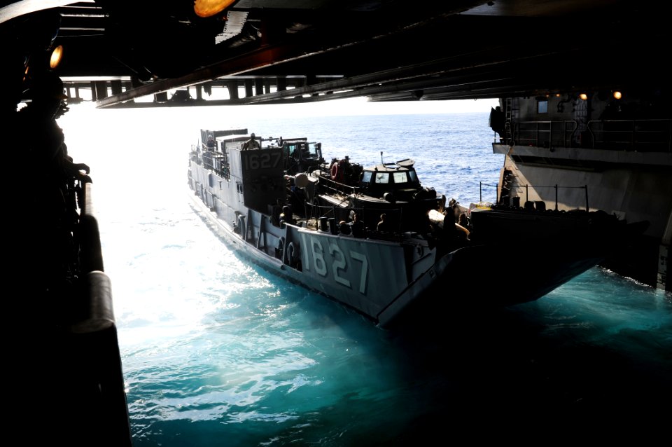 US Navy 111011-N-WA347-041 Landing craft utility (LCU) 1627 departs the well deck of the forward-deployed amphibious assault ship USS Essex (LHD 2)
