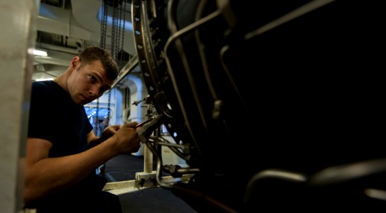 US Navy 111008-N-TU221-398 Airman Stefhan Spaulding tightens screws on the frame of a jet engine inside the jet shop of the Nimitz-class aircraft c