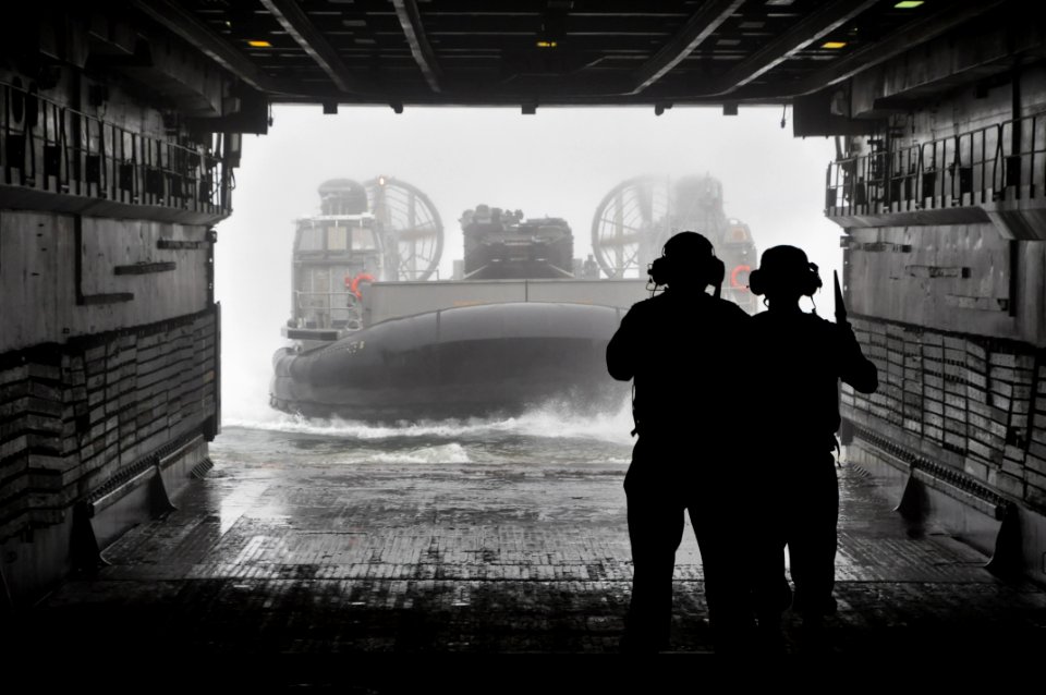 US Navy 111011-N-YX169-150 Chief Boatswain's Mate Oliver Simon, left, and Boatswain's Mate 3rd Class James Thompson direct a landing craft air cush