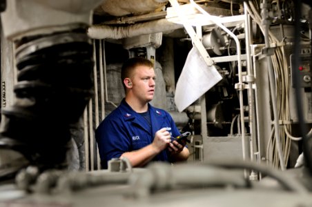 US Navy 111008-N-YM590-005 Engineman 2nd Class Kristopher Ruck monitors and logs boiler readings aboard the guided-missile cruiser USS Anzio (CG 68