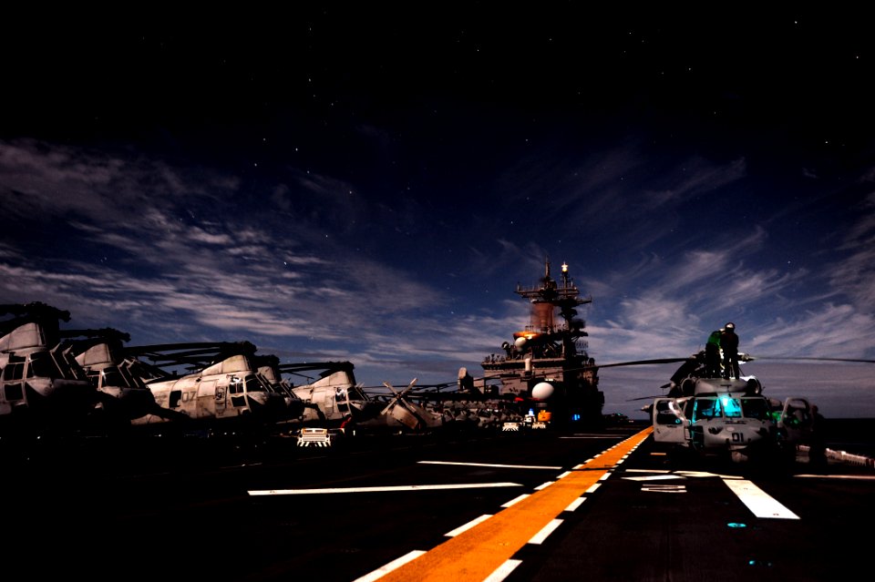 US Navy 111011-N-KM175-155 Moonlight illuminates the flight deck of the forward-deployed amphibious assault ship USS Essex (LHD 2)